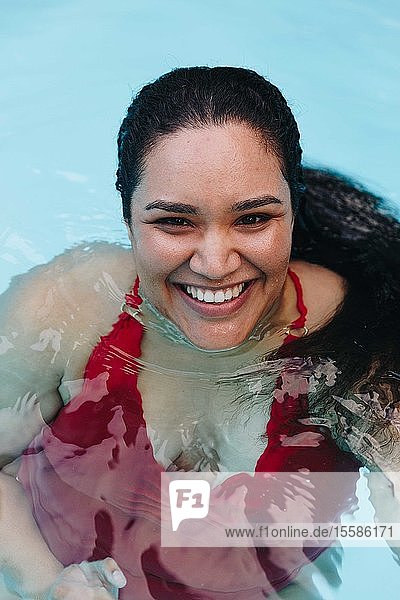 Mid adult woman with wet hair in outdoor swimming pool  portrait  Cape Town  South Africa
