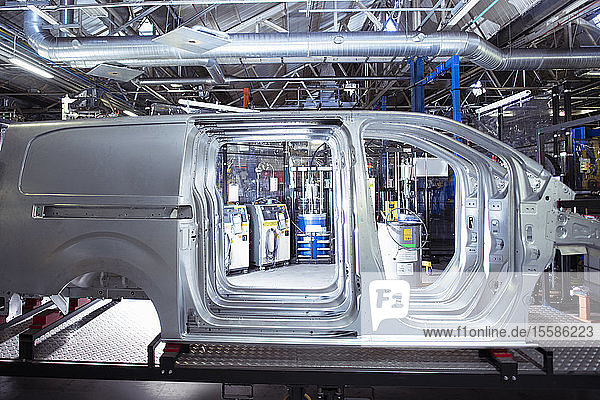 Side view of van bodies on production line in car factory