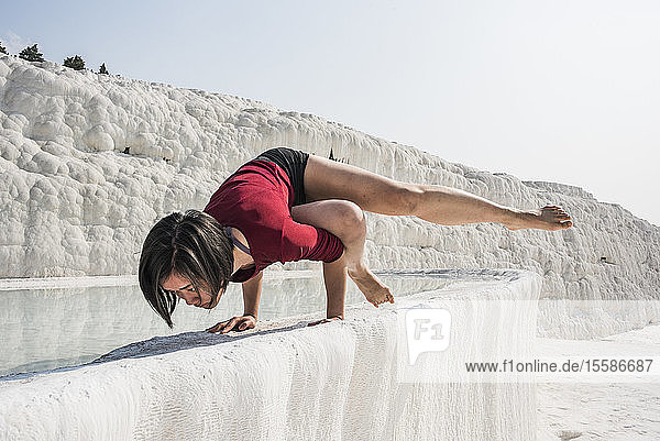 Woman practising yoga in cotton castle  Pamukkale  Denizli  Turkey