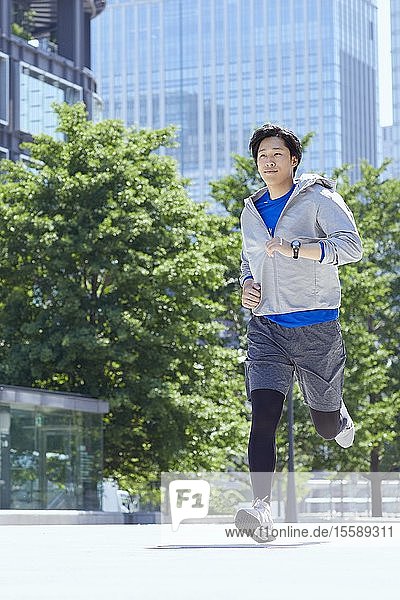 Junger Japaner läuft in der Innenstadt von Tokio