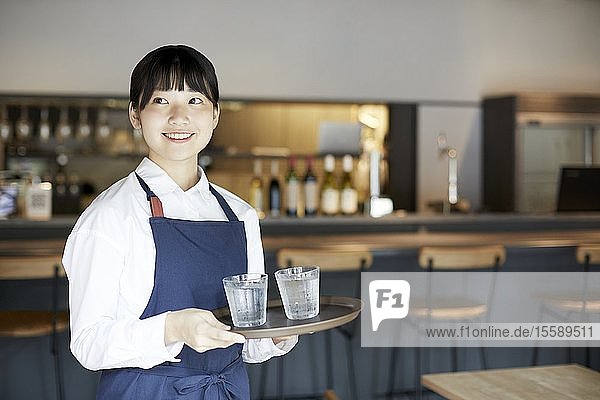Young Japanese woman working at a restaurant