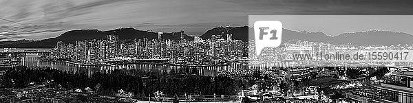Black and white panorama of lights illuminating the city of Vancouver at night; Vancouver British Columbia Canada