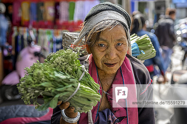 Senior woman selling vegetables at the market; Lashio  Shan State  Myanmar
