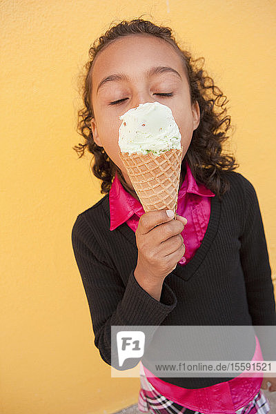 Hispanisches Mädchen isst ein Eis