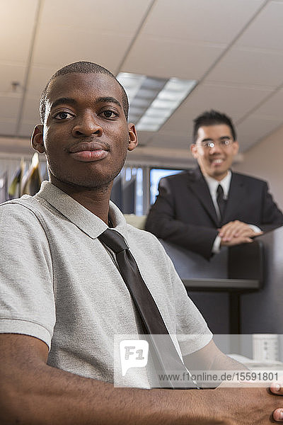 Portrait of two men with Autism working in an office