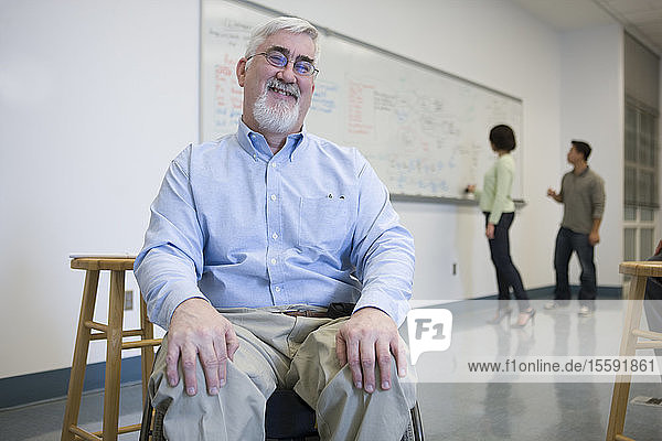 University professor with Muscular Dystrophy in a classroom