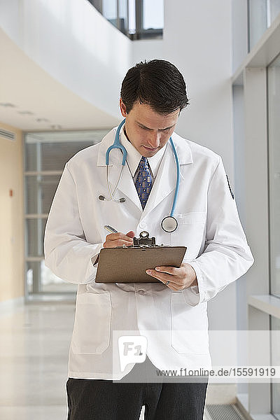 Doctor writing on a clipboard
