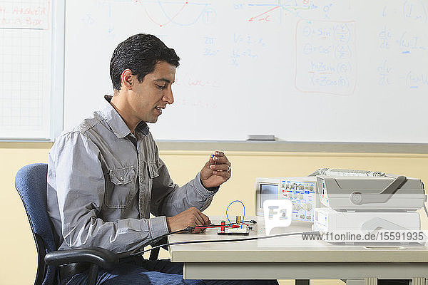 Ingenieurstudent bei der Vorbereitung eines Prototyping-Breadboards für ein Experiment im Elektroniklabor