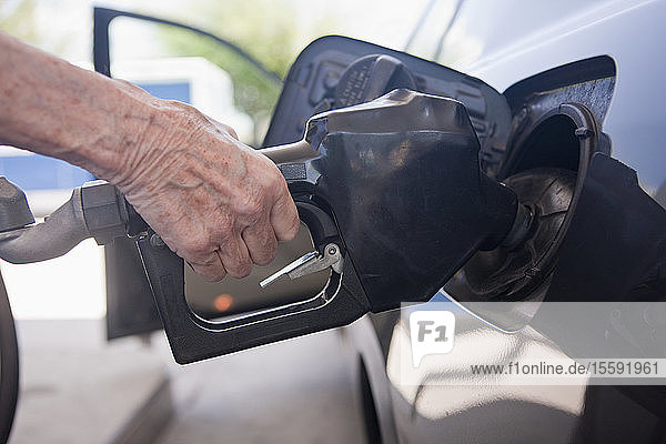 Woman filling car at a gas station