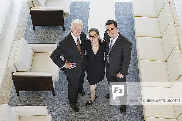 Portrait of businesspeople smiling in an office.