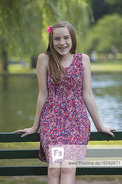 Portrait of happy Hispanic teen girl with braces in the park