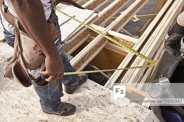 Carpenter holding a tape measure