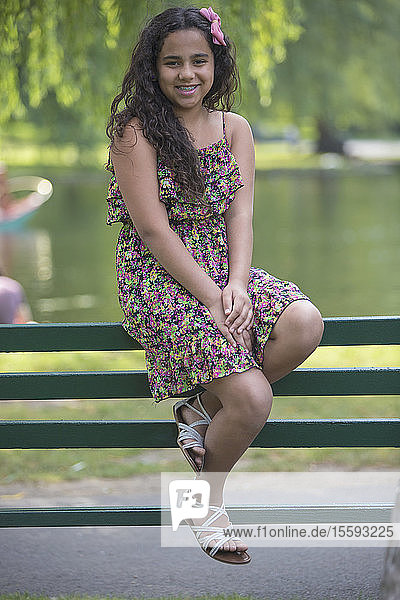 Portrait of Hispanic teen girl with braces sitting in the park