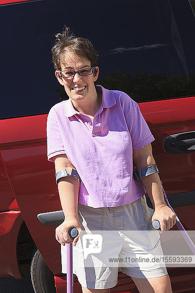 Woman with Cerebral Palsy in front of her adaptive van