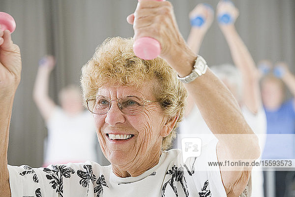 Senior woman exercising with hand weights