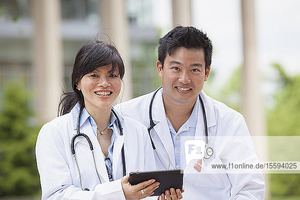 Doctors using a digital tablet