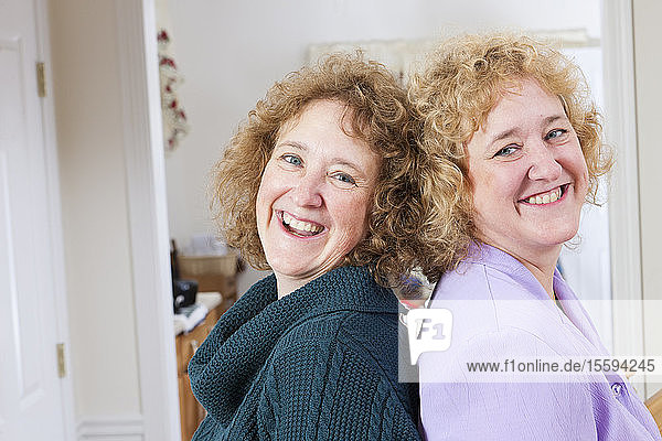 Portrait of twin sisters smiling