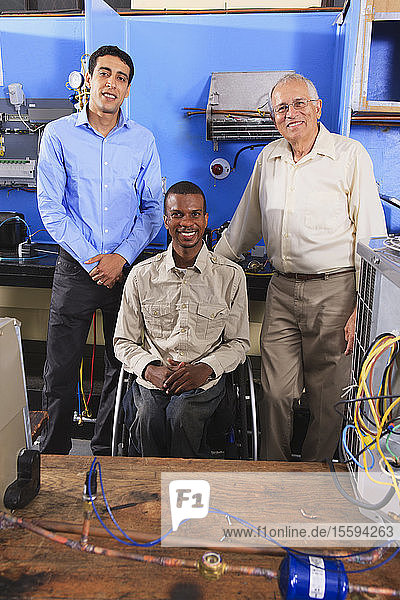 Instructor and two students in HVAC and process control classroom one student in wheelchair