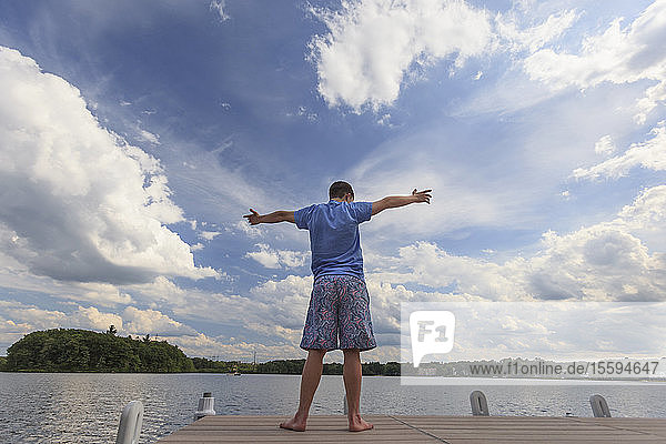 Young man with Down Syndrome playing on a dock