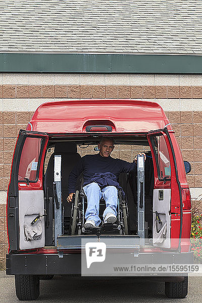 Man with spinal cord injury exiting his accessible van