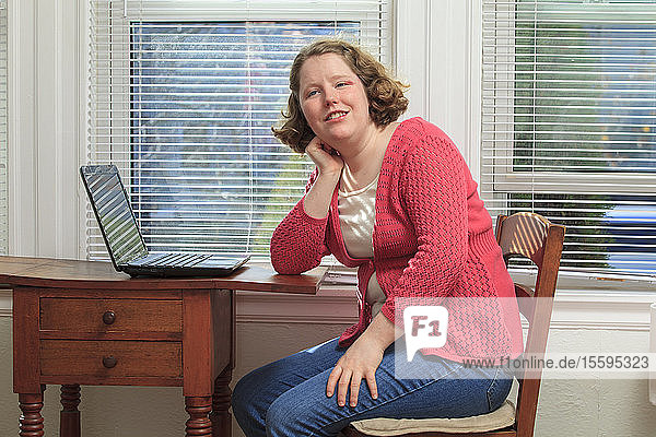 Young woman with Autism using her laptop