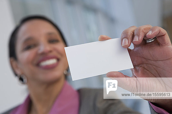 Hispanic woman holding a blank card