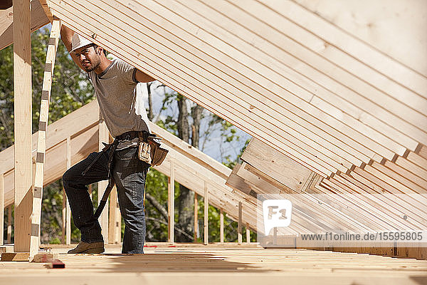 Carpenter placing roof framing
