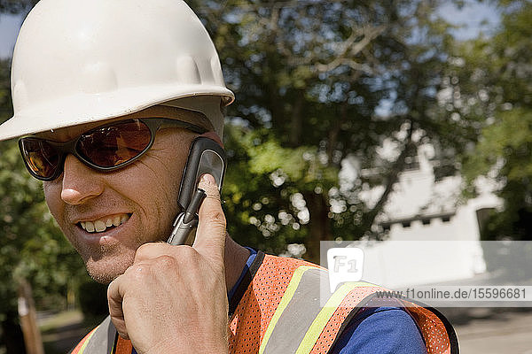 Construction worker talking on mobile phone
