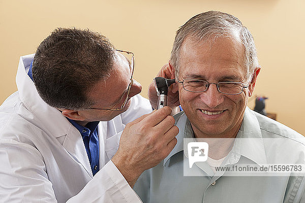 Audiologist doing an ear canal inspection