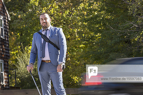 Businessman with Visual Impairment outside with his cane