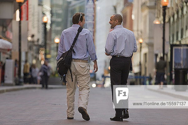 Two men walking together in a street