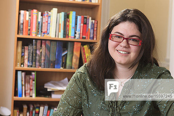 Portrait of a woman with Asperger syndrome and her books