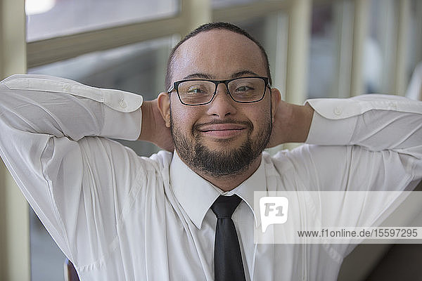 Porträt eines glücklichen afroamerikanischen Mannes mit Down-Syndrom als Kellner in einem Restaurant