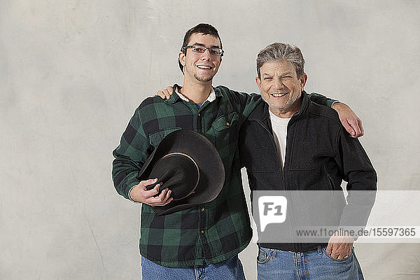 Portrait of a young man with autism and his mentor smiling