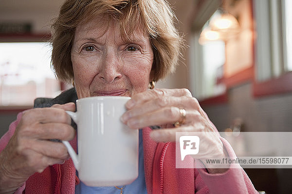 Woman drinking a cup of coffee in a cafe
