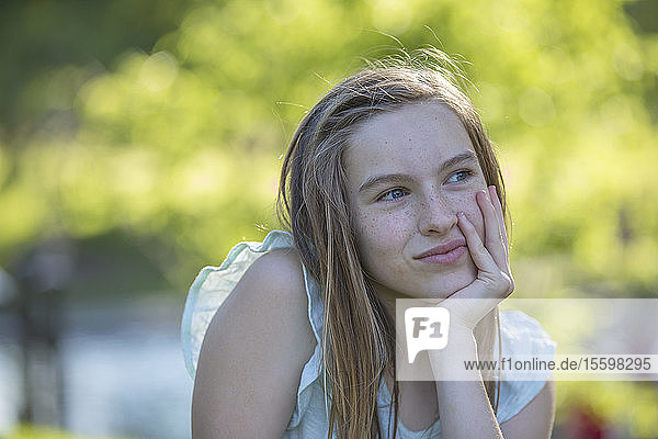 Portrait of happy Hispanic teen girl in park