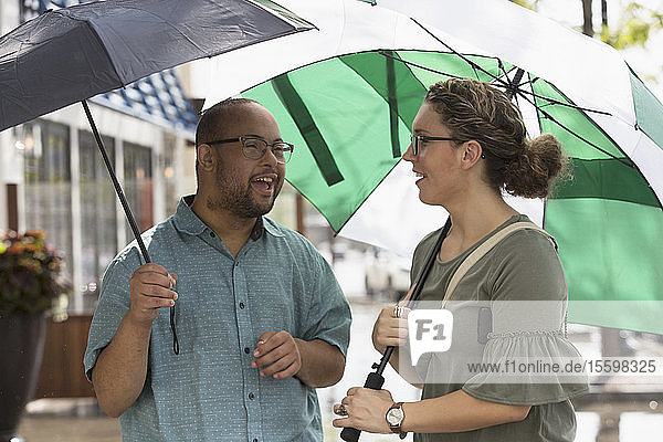Man with Down Syndrome and friend in rain