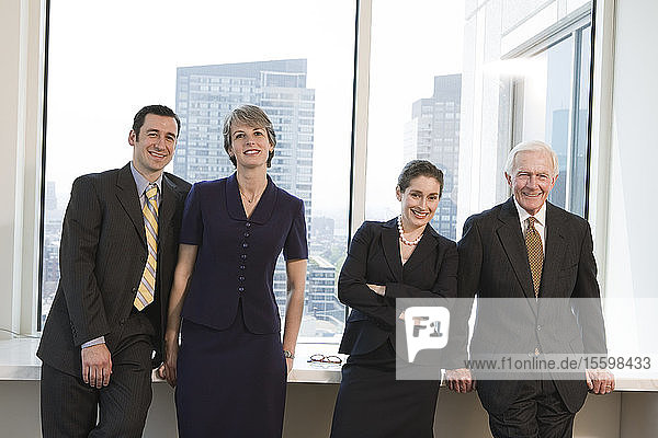 Businesspeople smiling in an office.