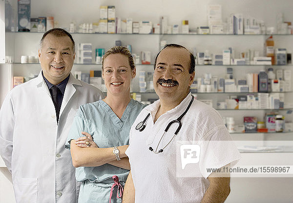 Ein Team von drei Ärzten lächelt in die Kamera