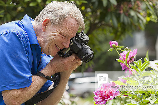 Man with Cerebral Palsy and dyslexia photographing his flowers
