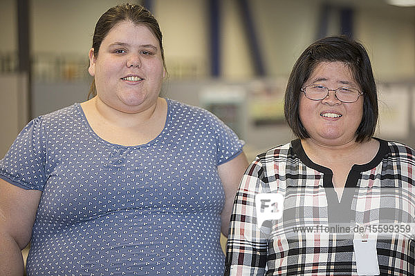 Portrait of two women with Learning Disabilities working in an office