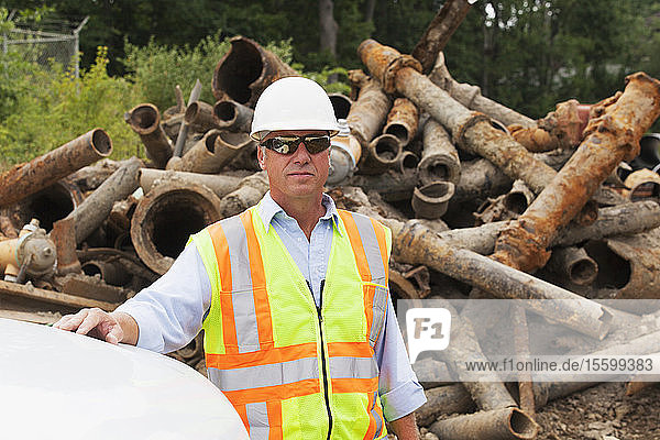 Engineer standing with old water pipes in the background