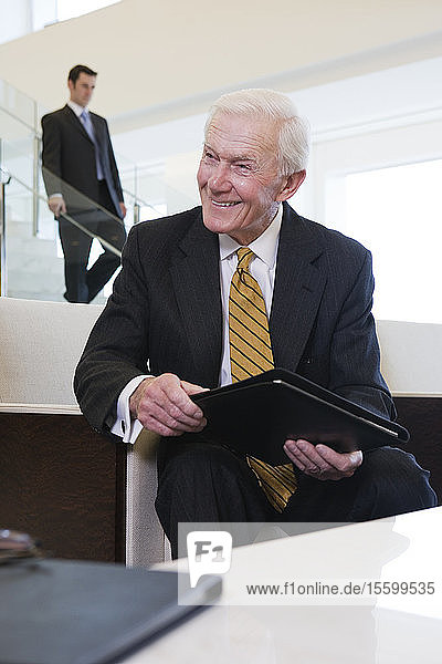 View of a cheerful businessman sitting in an office.