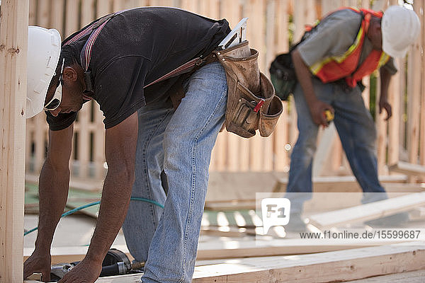 Carpenters working on house framing