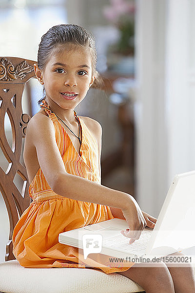 Portrait of a Hispanic girl working on a laptop