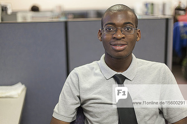 Portrait of African American man with Autism working in an office