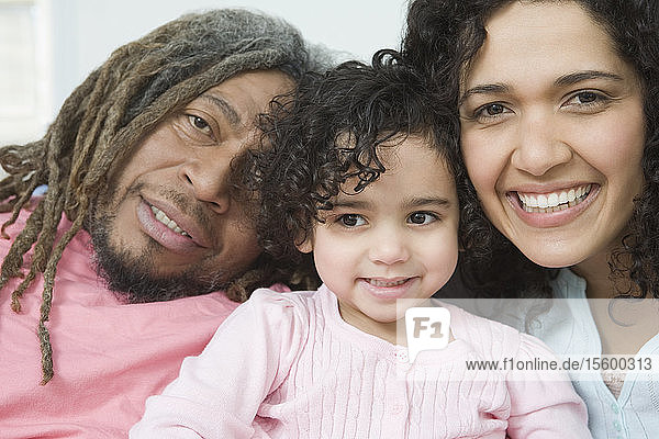 Portrait of a mid adult couple smiling with their daughter