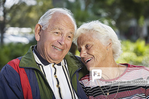 Senior couple smiling in a park.