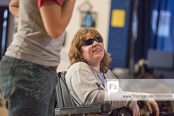 Woman with Cerebral Palsy and Visual impairment talking with other people in a meeting