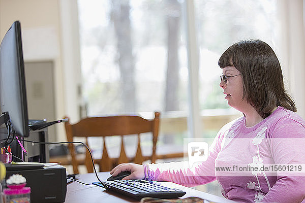 Mädchen mit Down-Syndrom benutzt ihren Computer